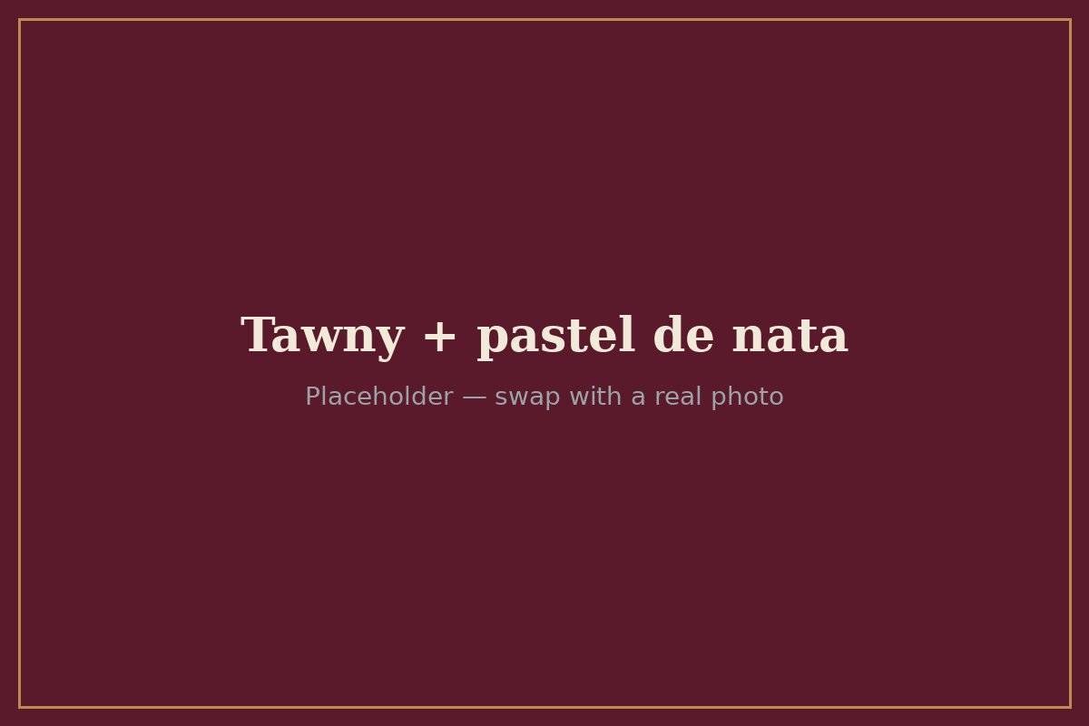 A glass of Tawny Port next to a pastel de nata